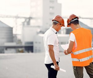 engineers-helmets-standing-by-factory-1-1