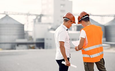engineers-helmets-standing-by-factory-1-1